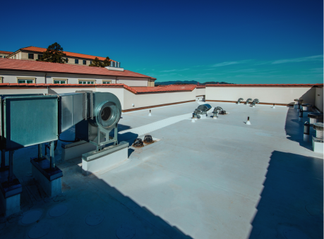 Flat commercial rooftop with HVAC units under clear skies — commercial roofing service in Suwanee, GA.