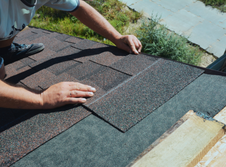 Roof repair technician installing asphalt shingles on a residential home in Suwanee, GA, for a trusted local roof repair company.